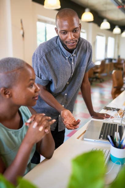 black people talking on desk